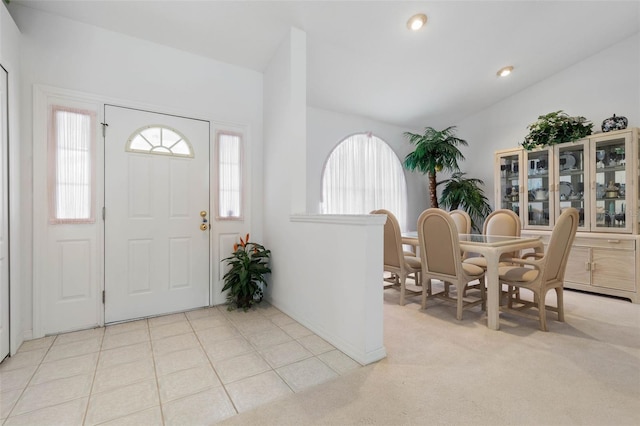 foyer entrance featuring a wealth of natural light, light colored carpet, recessed lighting, and light tile patterned floors