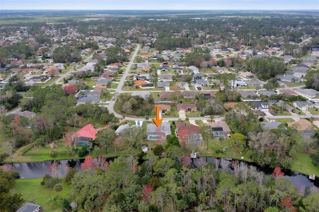 birds eye view of property featuring a water view and a residential view