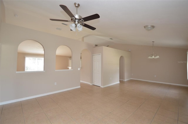 empty room with light tile patterned floors, baseboards, visible vents, vaulted ceiling, and ceiling fan with notable chandelier