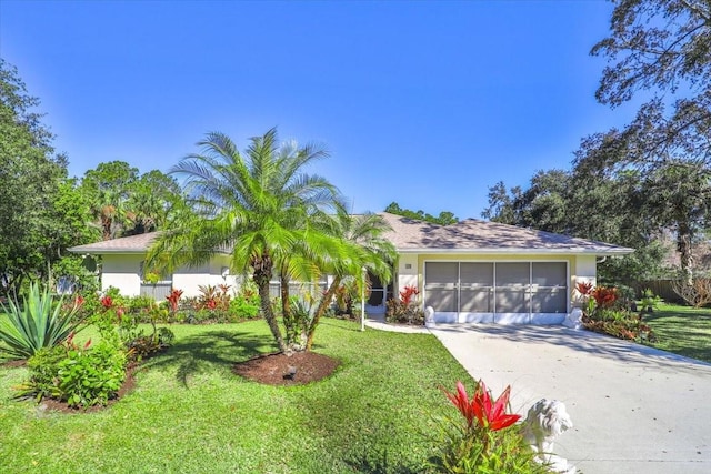 view of front of property with a garage, concrete driveway, a front lawn, and stucco siding