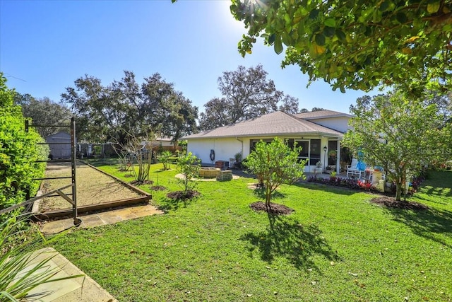 view of yard featuring fence and a garden