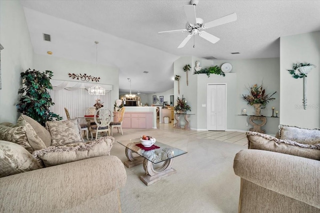 living area with visible vents, light carpet, vaulted ceiling, a textured ceiling, and ceiling fan with notable chandelier