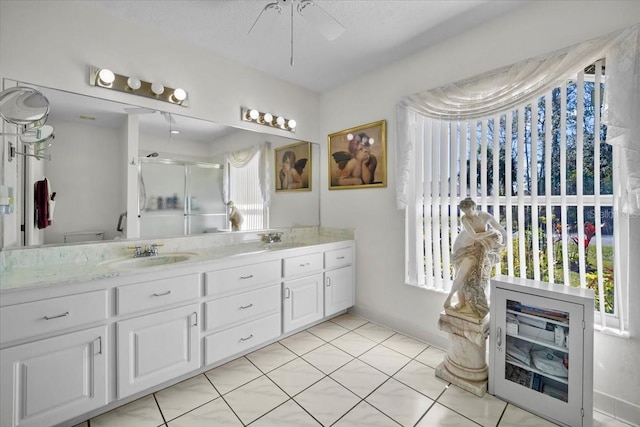 full bathroom with a stall shower, ceiling fan, a wealth of natural light, and vanity