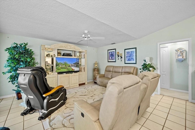 living area featuring light tile patterned floors, ceiling fan, a textured ceiling, and vaulted ceiling