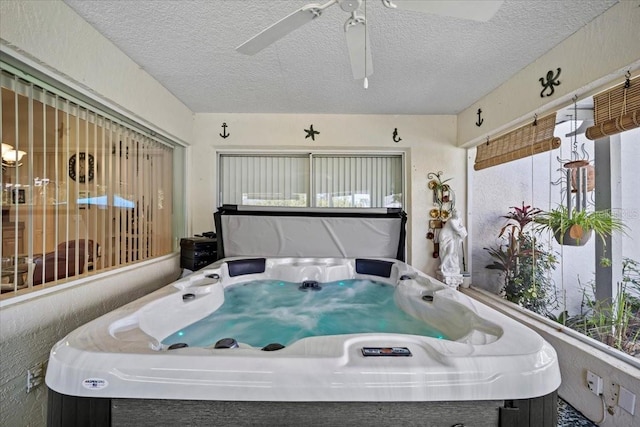 miscellaneous room featuring a hot tub and a textured ceiling