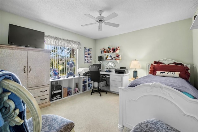 bedroom featuring a ceiling fan, a textured ceiling, and light colored carpet