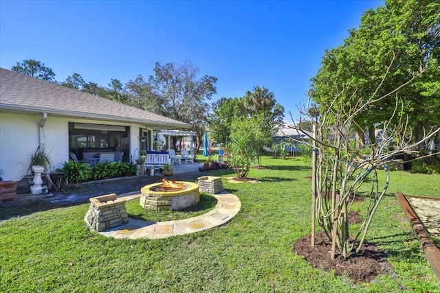 view of yard with an outdoor fire pit and a patio area