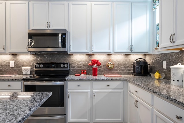 kitchen with stainless steel appliances and white cabinets