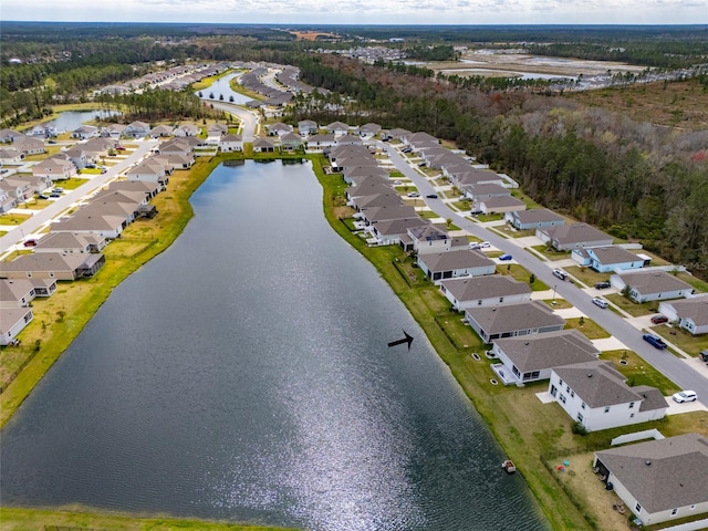 drone / aerial view featuring a water view and a residential view