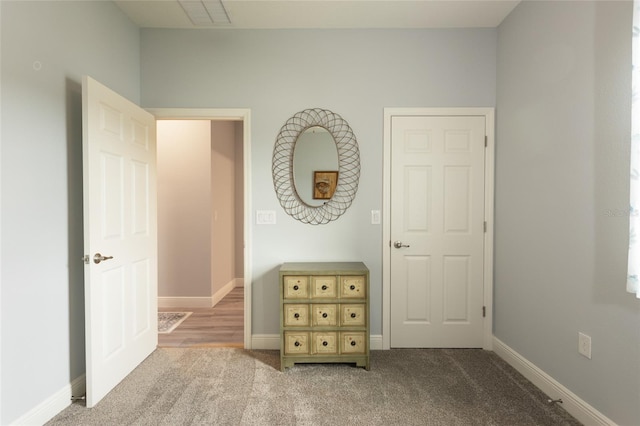 unfurnished bedroom with baseboards, visible vents, and light colored carpet