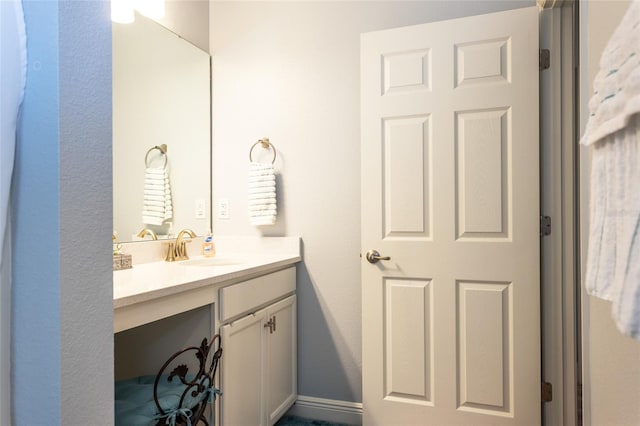 bathroom featuring baseboards and vanity