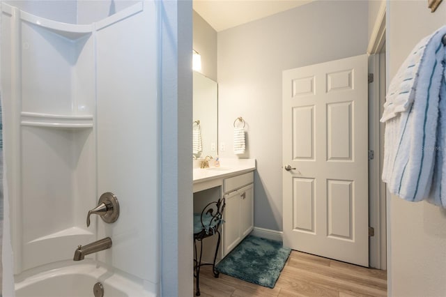 full bathroom featuring shower / tub combination, wood finished floors, and vanity