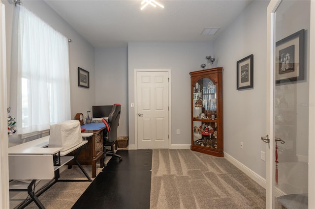 office space featuring carpet floors, visible vents, and baseboards