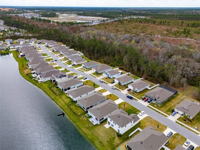 birds eye view of property with a water view and a residential view