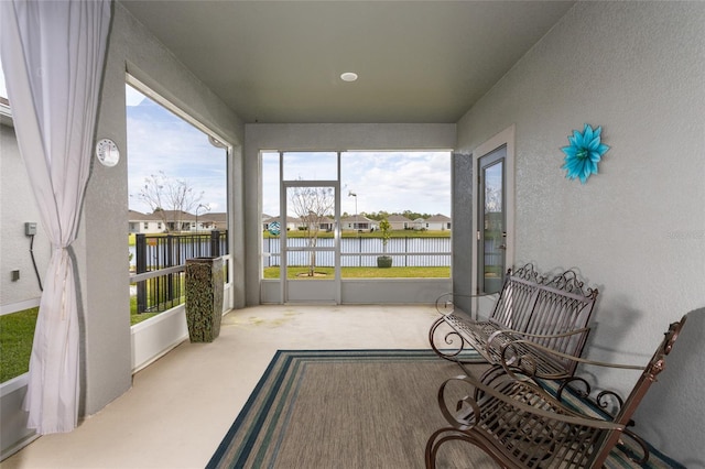 sunroom / solarium with a water view