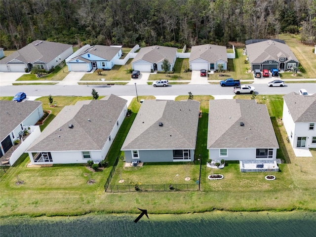 bird's eye view featuring a water view and a residential view