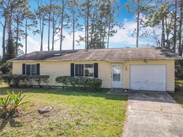 ranch-style home featuring an attached garage, concrete driveway, and a front yard