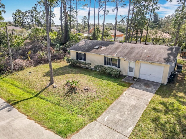 view of front of property with a garage, a front yard, and driveway