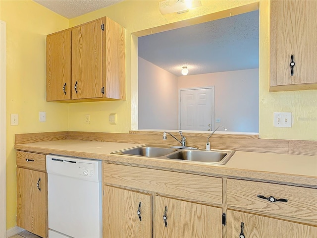 kitchen with light brown cabinets, light countertops, white dishwasher, and a sink