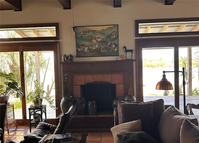 living area featuring light tile patterned floors, a fireplace, and a wealth of natural light