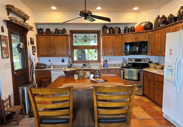 kitchen featuring light countertops, white appliances, brown cabinetry, and decorative backsplash