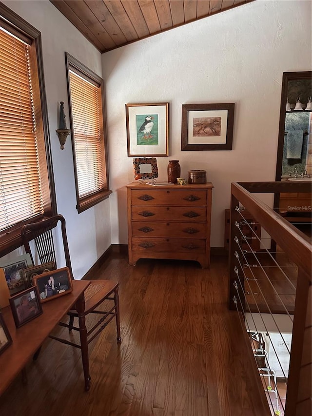 hallway with dark wood-style flooring, wooden ceiling, and baseboards