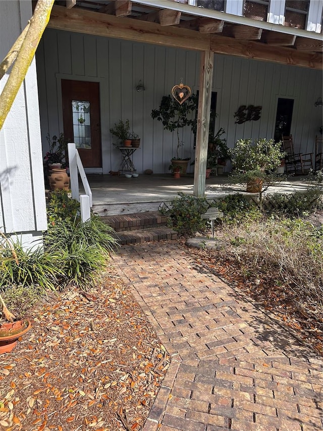 view of exterior entry with covered porch