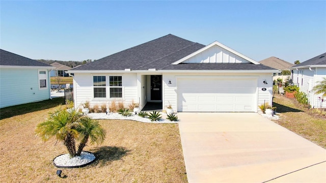 single story home with a garage, concrete driveway, a front lawn, and board and batten siding