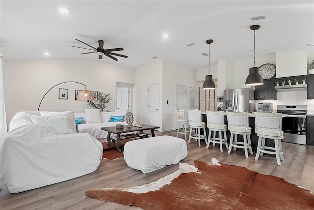 living area featuring recessed lighting, visible vents, ceiling fan, and light wood-style flooring