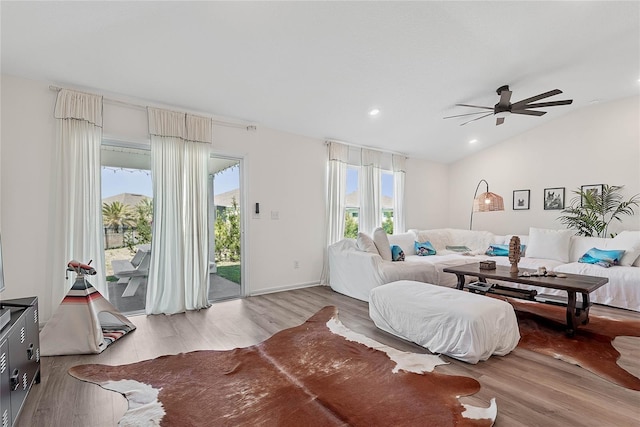 interior space with vaulted ceiling, recessed lighting, wood finished floors, and access to exterior