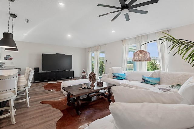 living area featuring ceiling fan, wood finished floors, visible vents, and recessed lighting