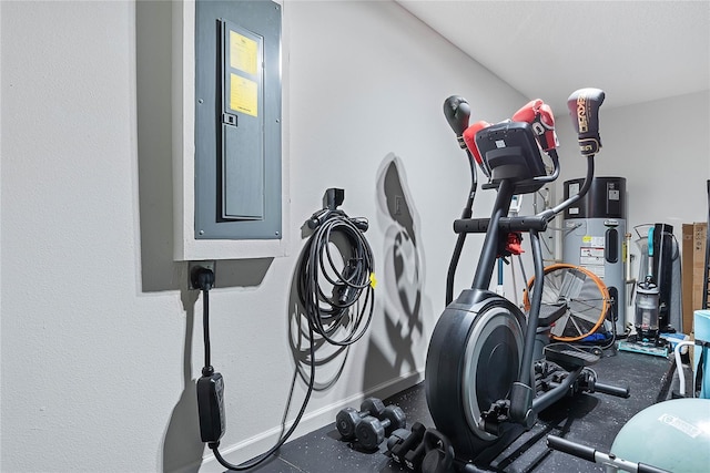 exercise room featuring water heater, electric panel, and baseboards