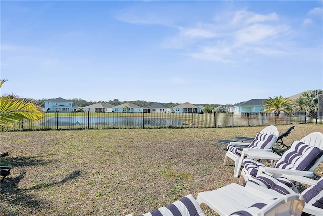 view of yard featuring a residential view and fence