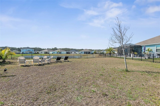 view of yard featuring a residential view and fence