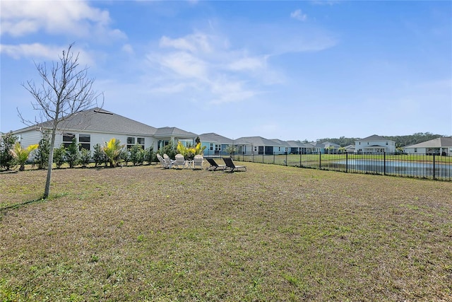 view of yard featuring fence and a residential view