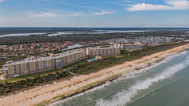 birds eye view of property with a view of city, a beach view, and a water view