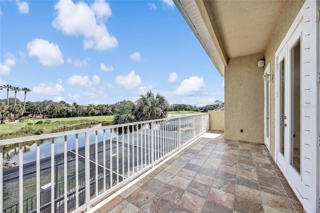 balcony with french doors and a water view