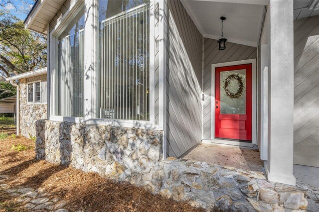 doorway to property with stone siding