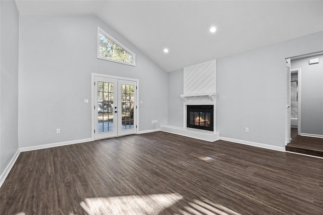 unfurnished living room featuring a fireplace, baseboards, dark wood-type flooring, and french doors