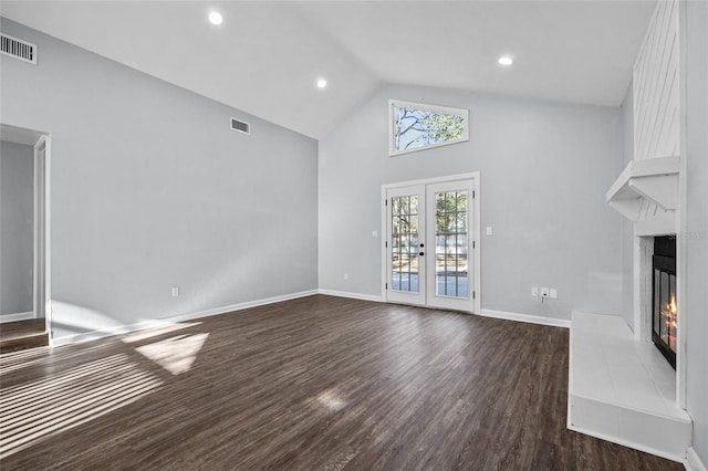 unfurnished living room with a large fireplace, dark wood-type flooring, visible vents, baseboards, and french doors