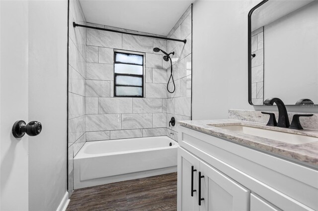 full bathroom featuring shower / washtub combination, vanity, and wood finished floors