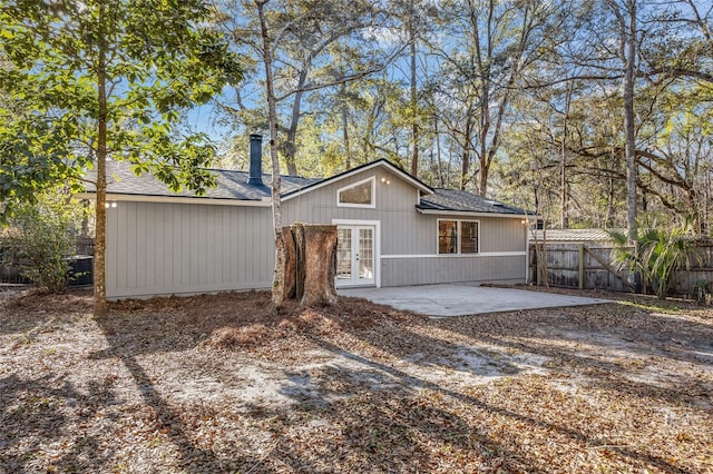 back of property with french doors, a patio area, and fence