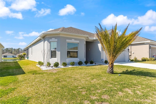 view of front facade with concrete driveway, a front lawn, an attached garage, and stucco siding