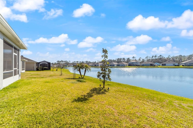 view of yard with a water view and a residential view