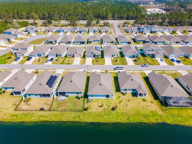 bird's eye view featuring a water view and a residential view