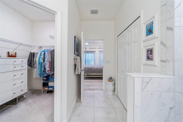 interior space featuring marble finish floor, baseboards, and visible vents