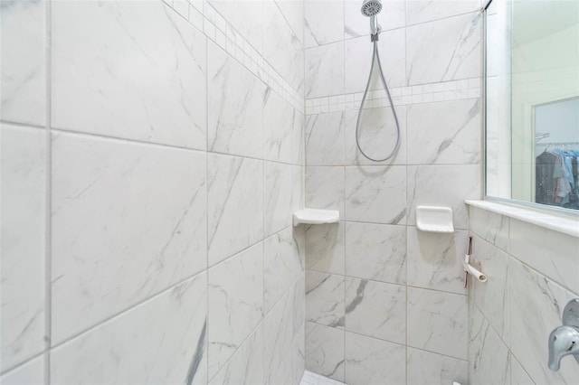 full bath with a tile shower