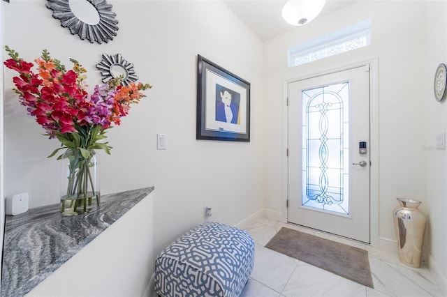 foyer featuring baseboards