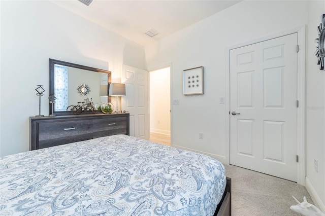 bedroom featuring light carpet and baseboards