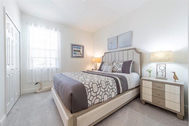 bedroom featuring carpet, a closet, and baseboards